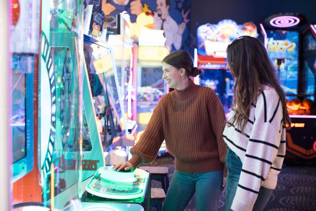 Two people playing a game at an arcade